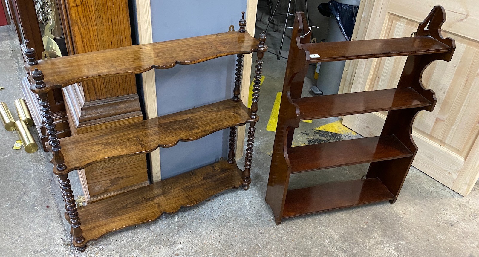 A Victorian walnut serpentine three tier wall bracket width 80cms, height 89cms and a later Victorian mahogany four tier wall bracket.